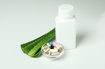 Concept of natural herb pills with aloe on white background, a Beauty & Fashion Photo by AtlasStudio PRO