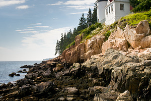 Bass harbor head lighthouse featuring light house, cliff, and sky
