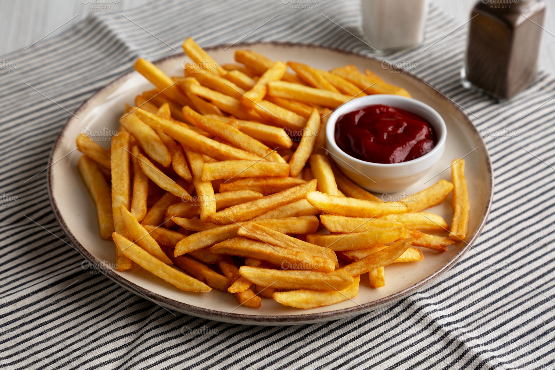 Homemade Golden French Fries with Ketchup, side view., a Food & Drink Photo by LiudmylaChuhunova