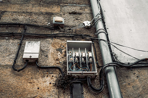 Old electrical box on stone wall, a Technology Photo by SkyNext