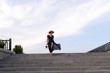 Woman in polka dot dress descends