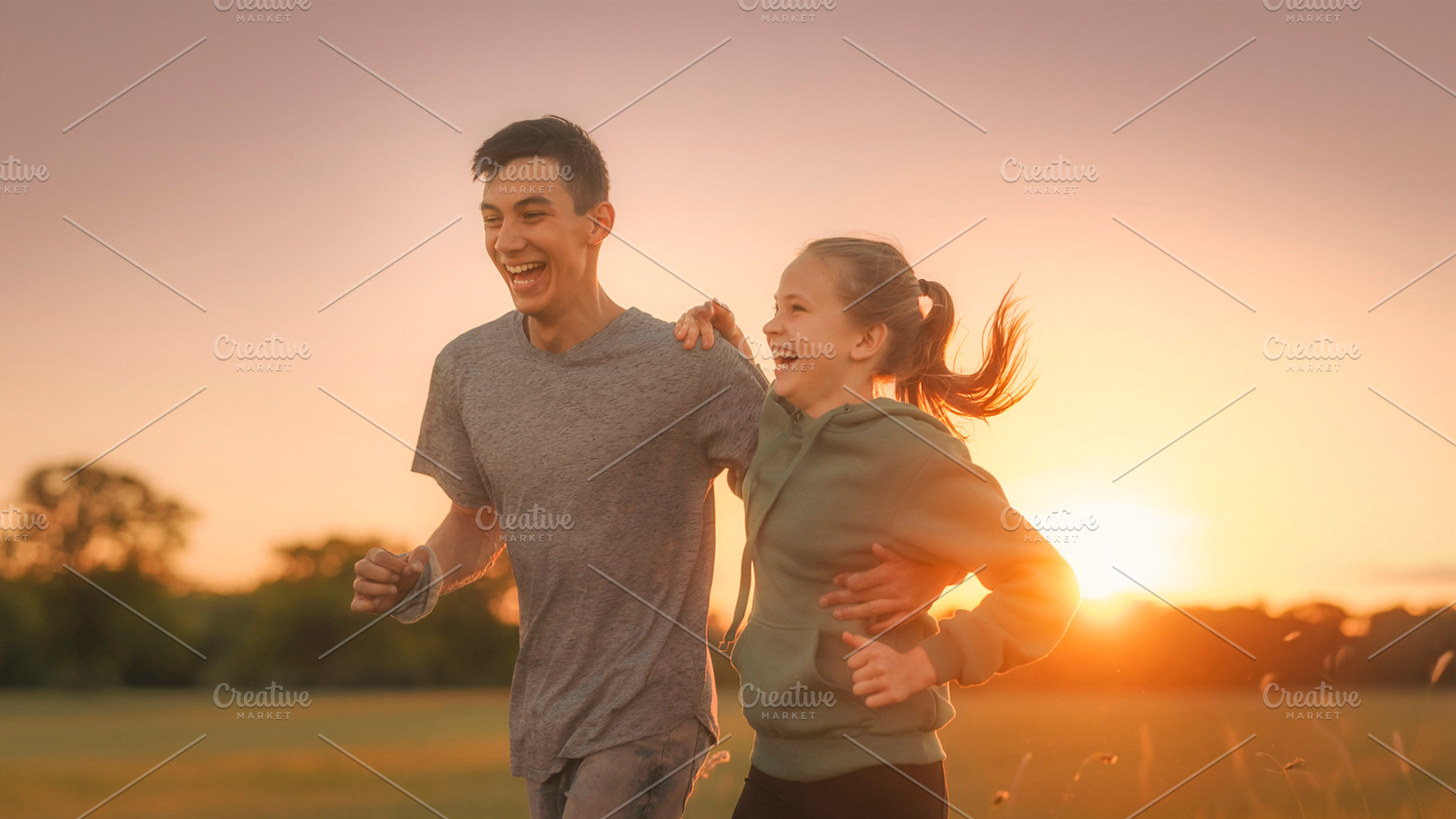 Two young people jogging together at sunset, a Photo by DanFLCreativo