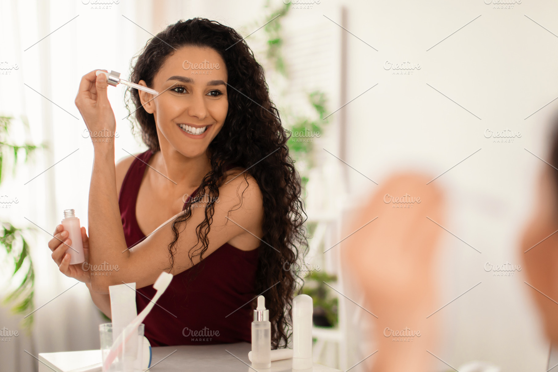 Beauty cosmetics for young skin. Attractive young woman applying moisturizing s, a Photo by Prostock-Studio