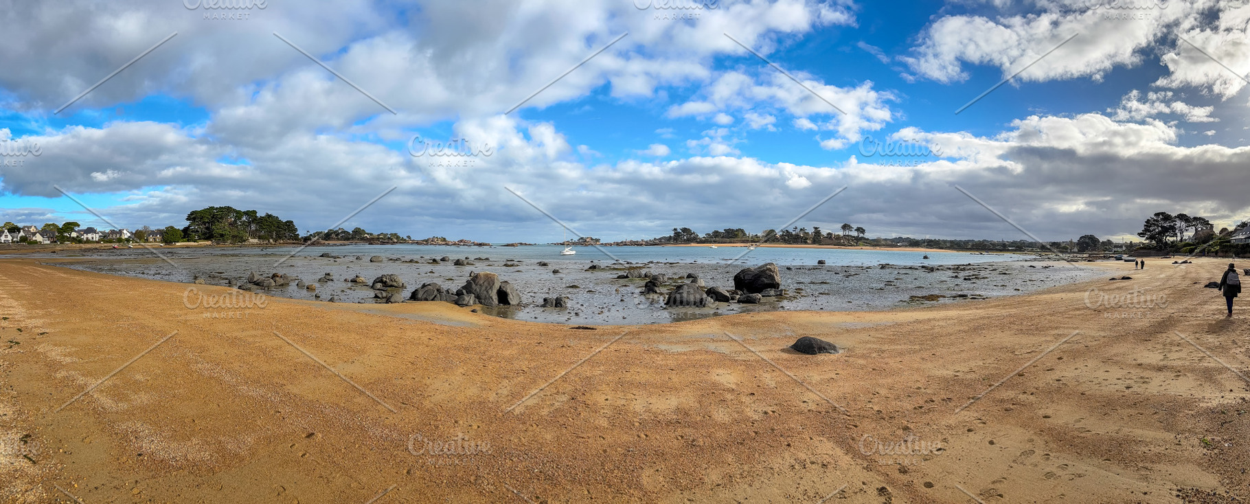 Wide sandy bay with scattered granite rocks in Tregastel Brittan, a Nature Photo by GoodGoods