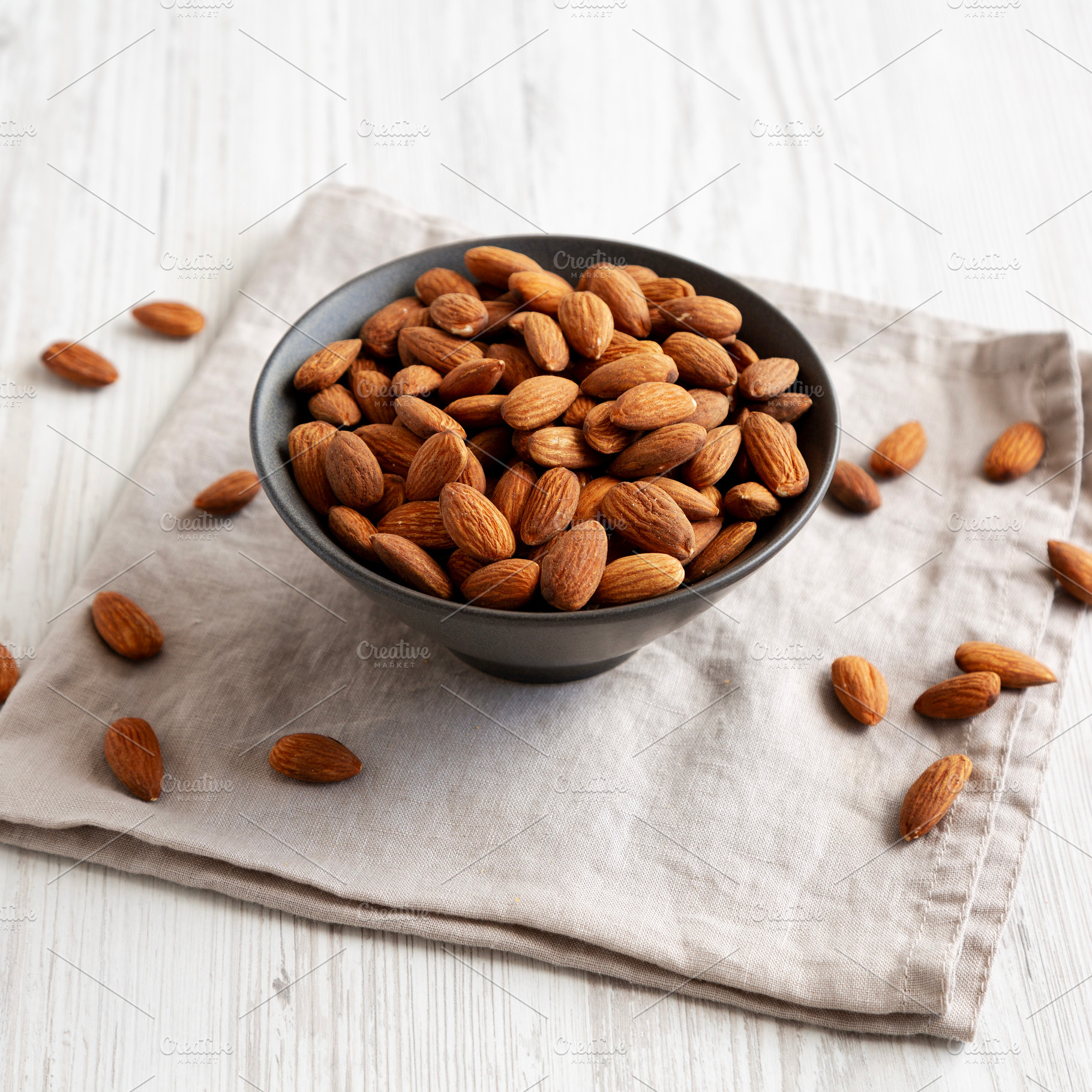 Roasted Almonds in a Bowl, side view., a Food & Drink Photo by LiudmylaChuhunova