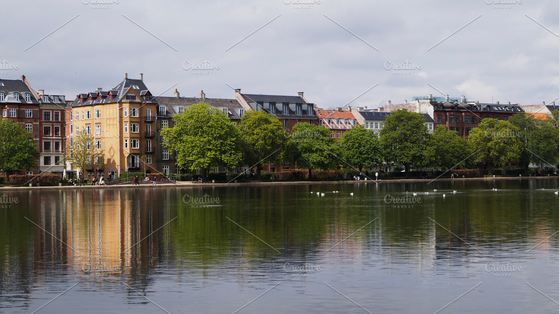 The Lakes. Scenic urban waterfront view with historic buildings and trees in Co, a Photo by AS photostudio