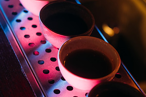 Asian pub sake cup row neon alcoholic pub counter, a Food & Drink Photo by Photo Drive Studio
