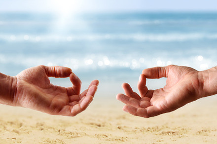 Detail of hands with meditation gesture on a beach, a Health & Medical Photo by Davizro's Market