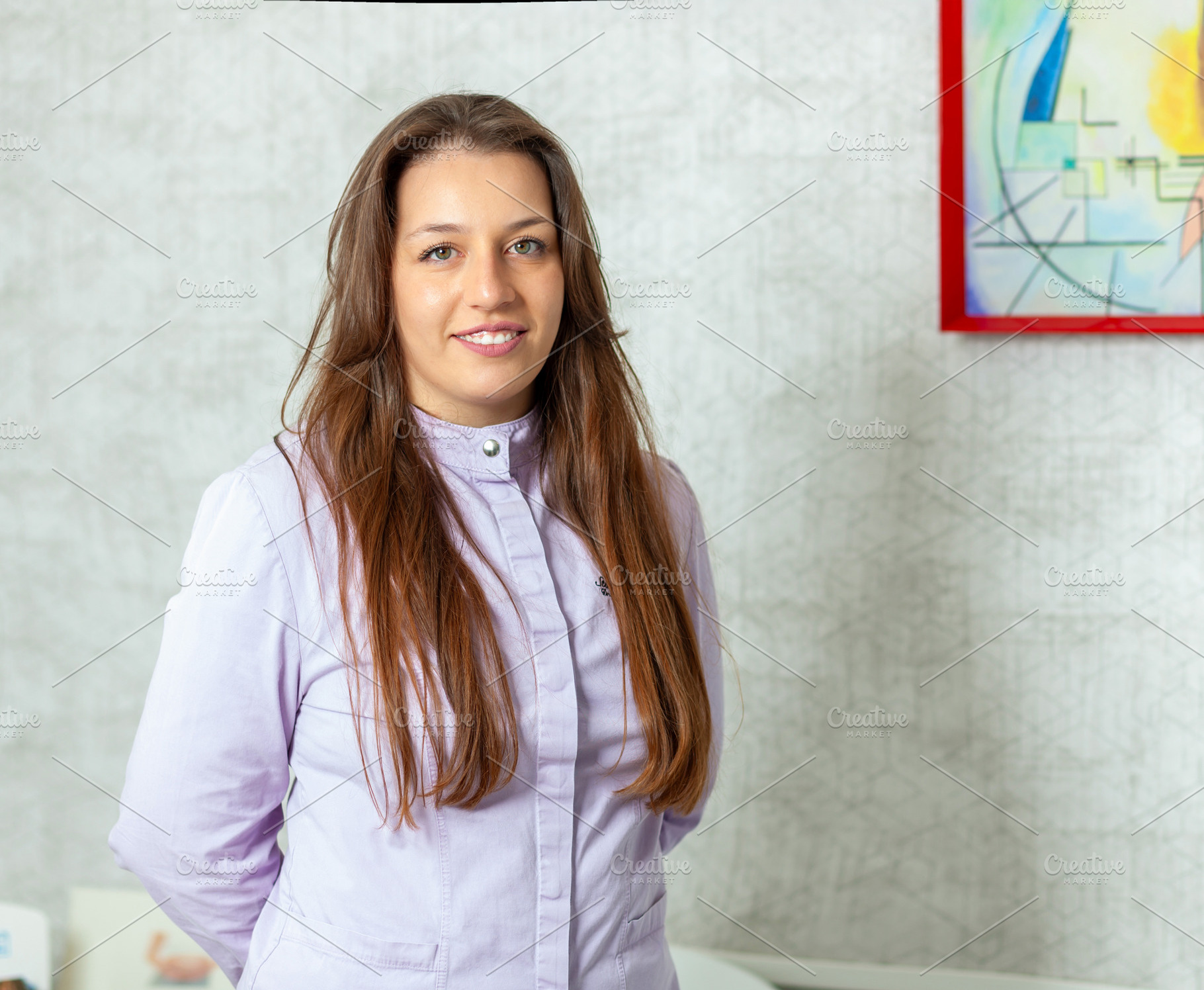 Young female doctor smiling at the camera in her office, a Health & Medical Photo by Antonio Gravante Market
