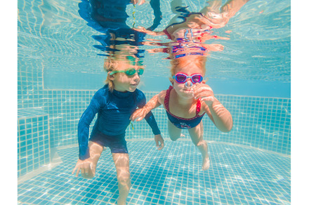 Kids having fun playing underwater, a Person Photo by Elizaveta Galitskaya