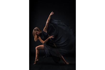 Young beautiful dancer in beige dress dancing on black background featuring, a Sports & Recreation Photo by Volodymyr Melnyk