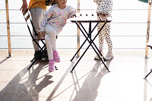 Children outdoors enjoying a sunny day by the water on a wooden deck, a Person Photo by AS photostudio