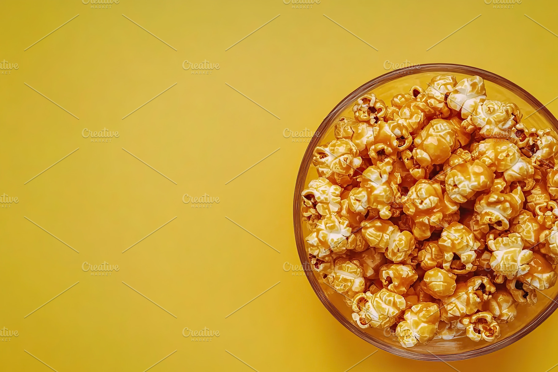 Bowl filled with delicious caramel popcorn on a bright yellow background, a Food & Drink Photo by AlyaAnd