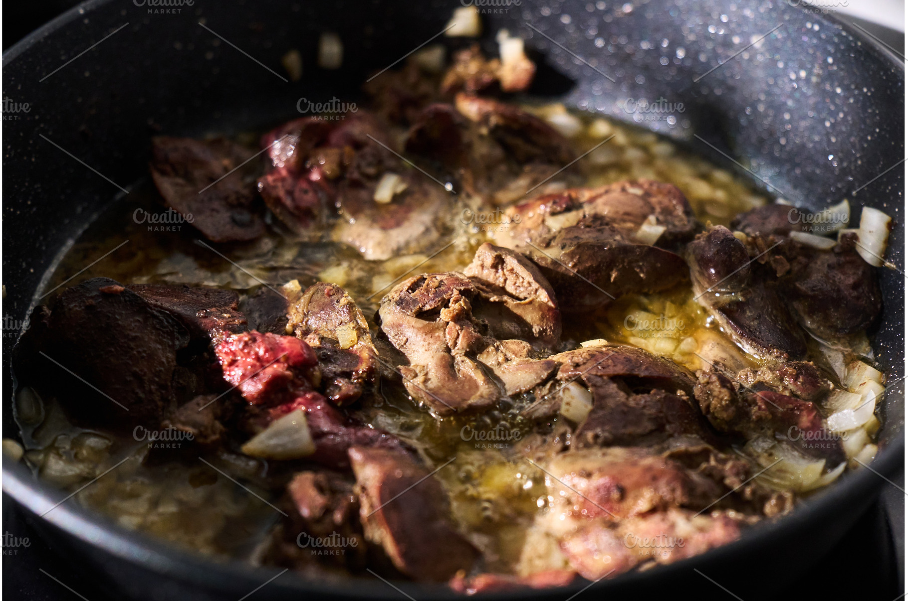 Cooking liver pieces in a frying pan, a Background Photo by darksoul72