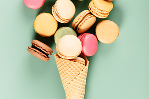 Colorful Macarons in Ice Cream Cone on Pastel Background, a Holiday Photo by Natalia Klenova's Shop