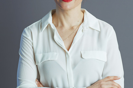 happy young small business owner woman against gray background, a Person Photo by Alliance Images
