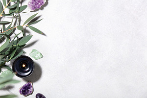 Wellness Background with Eucalyptus, Crystals and Burning Candle