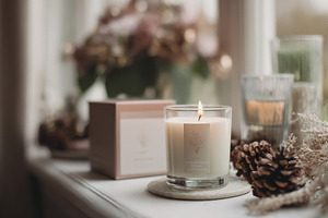 Cozy home decor creating a relaxing atmosphere with a lit candle, a Photo by Studio ANNA
