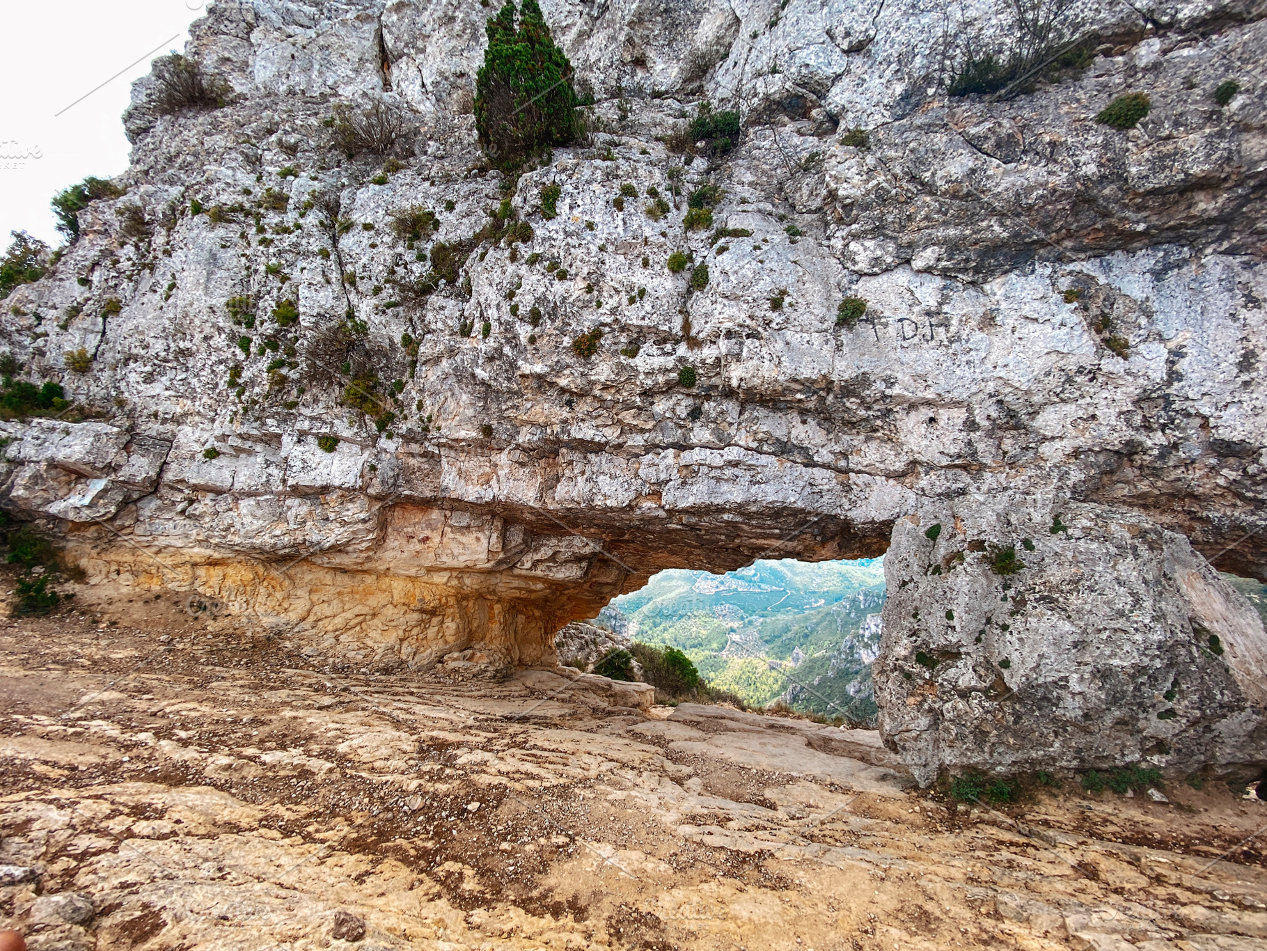 wide shot of La Foradada rock arch in Spain, a Photo by Nito