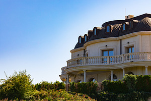 Luxurious mansion with classic architectural details, manicured greenery, and c, an Architecture Photo by Ales Munt