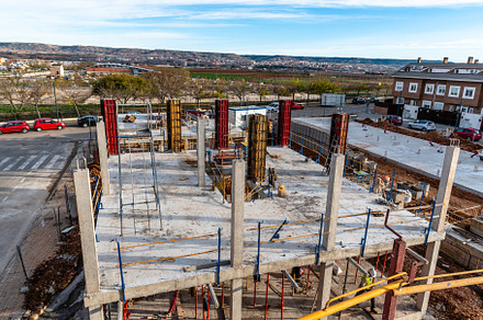 Construction site with steel formworks and reinforcing bars for pillars ready f