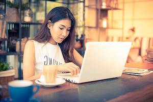 Woman in coffee shop containing coffee, app, and asian