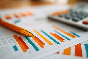 Colorful financial report with graphs and calculator, a Business Photo by AlyaAnd