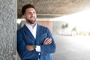 Confident businessman smiling outside office building, a Business Photo by etorres69