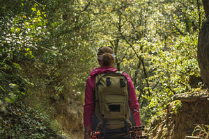 Trekking woman containing activity, adventure, and backpack