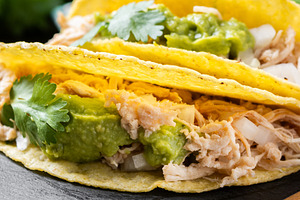 Mexican chicken tacos with guacamole and cilantro