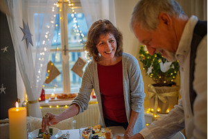 Older couple preparing table for, a Holiday Photo by HalfPoint