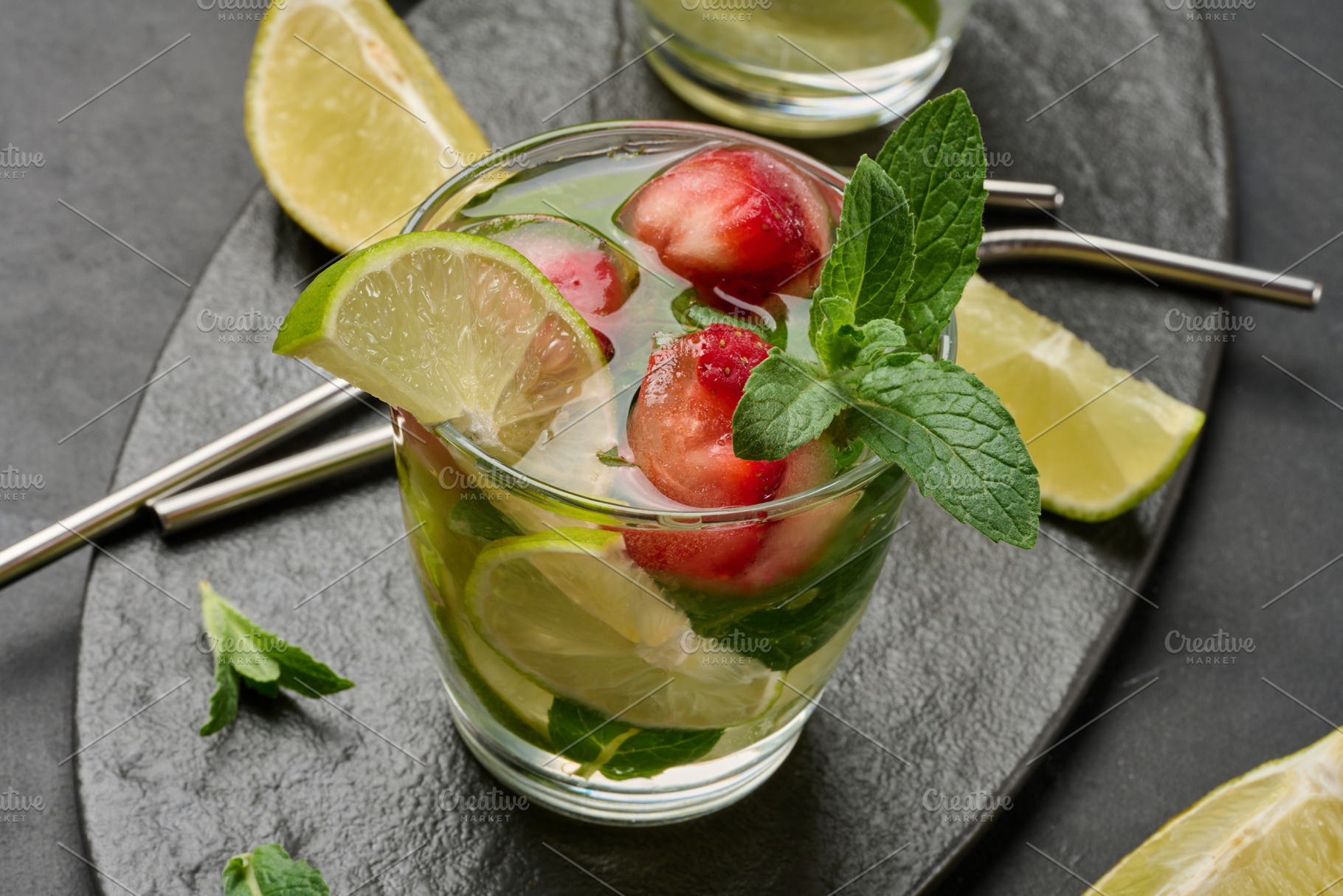 Refreshing mojito cocktail with lime, mint, strawberry, and ice, a Food & Drink Photo by ndanko