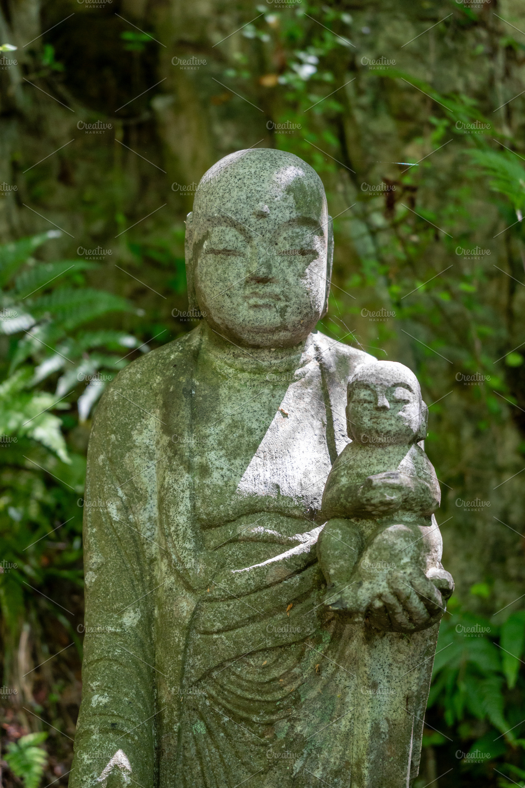 Jizo Bosatsu statue holding baby at Mitaki-Dera in Hiroshima, a Nature Photo by GoodGoods