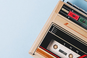 Old cassette tape recorder on a blue