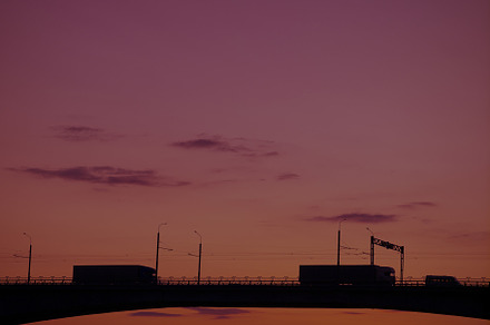 Silhouette of a bridge over a river featuring cityscape, river, and bridge, a Transportation Photo by oleghz