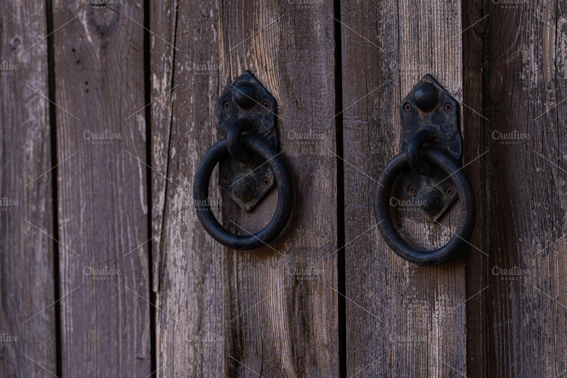 Metal handles on the old wooden door background, an Architecture Photo by Anna Bogush