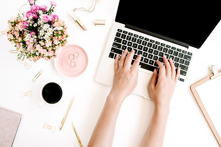 Girl working on laptop containing wildflowers, laptop, and typing, a Business Photo by Floral Deco