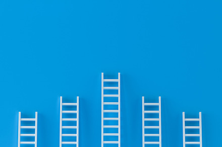 Ladder achievement on blue wall, a Business Photo by Zama Studio