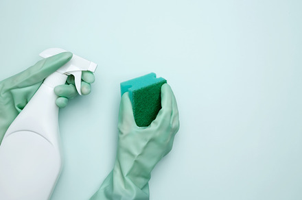 House cleaning. Womans hand in rubber glove holds green dishwashing sponge and, a Photo by matucha