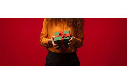 Close-up of young woman holding gift, a Person Photo by HalfPoint