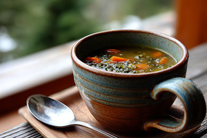 Rustic mug with clear vegetable soup, a Food & Drink Photo by MistyDay
