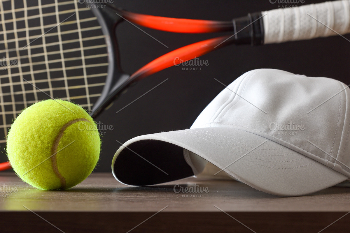 Tennis Ball and White Cap Beside a Racket, a Sports & Recreation Photo by Davizro's Market (Photo 1 of 2)