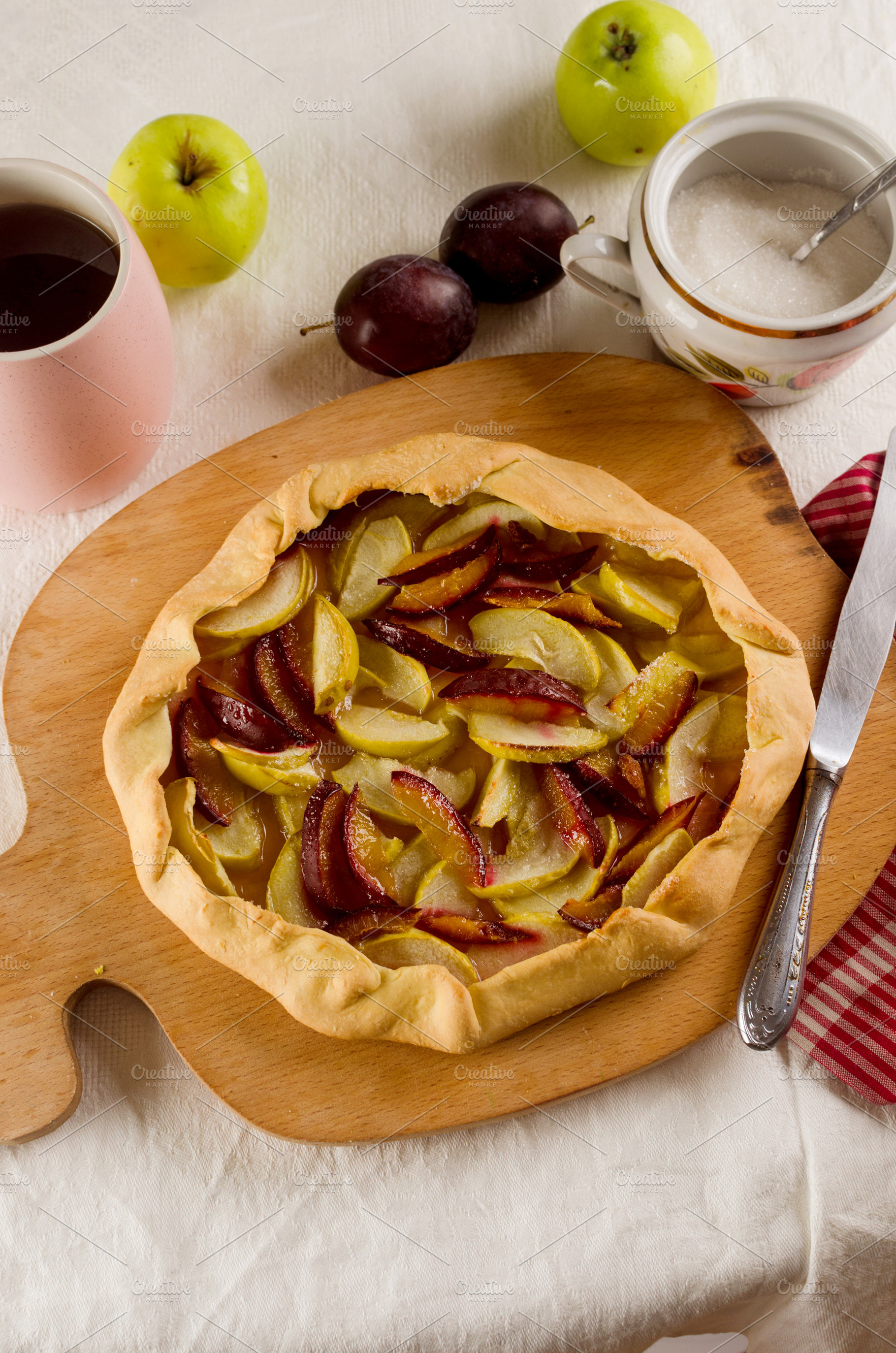 Homemade apple and plum galette table for teatime, a Food & Drink Photo by vimart