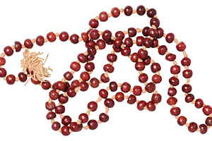 A string of red beads, made from sandalwood, with a light tassel, an Abstract Photo by ndanko