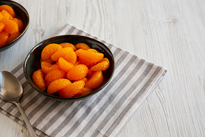 Organic Canned Mandarin Oranges in Bowls, side view. Copy space., a Food & Drink Photo by LiudmylaChuhunova