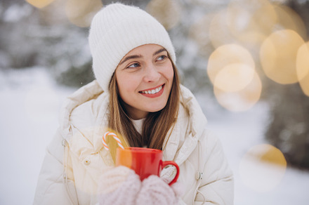 Cute happy woman holding hot coffee, a Holiday Photo by Cherkas Photography
