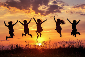 Children jump joyfully at sunset, a Photo by Pavel_design