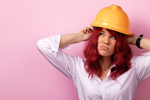 Confident woman in white shirt wearing yellow construction helme, a Person Photo by Ales Munt