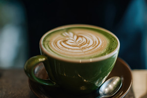 Coffee in green cup with design, a Photo by Beautiful things