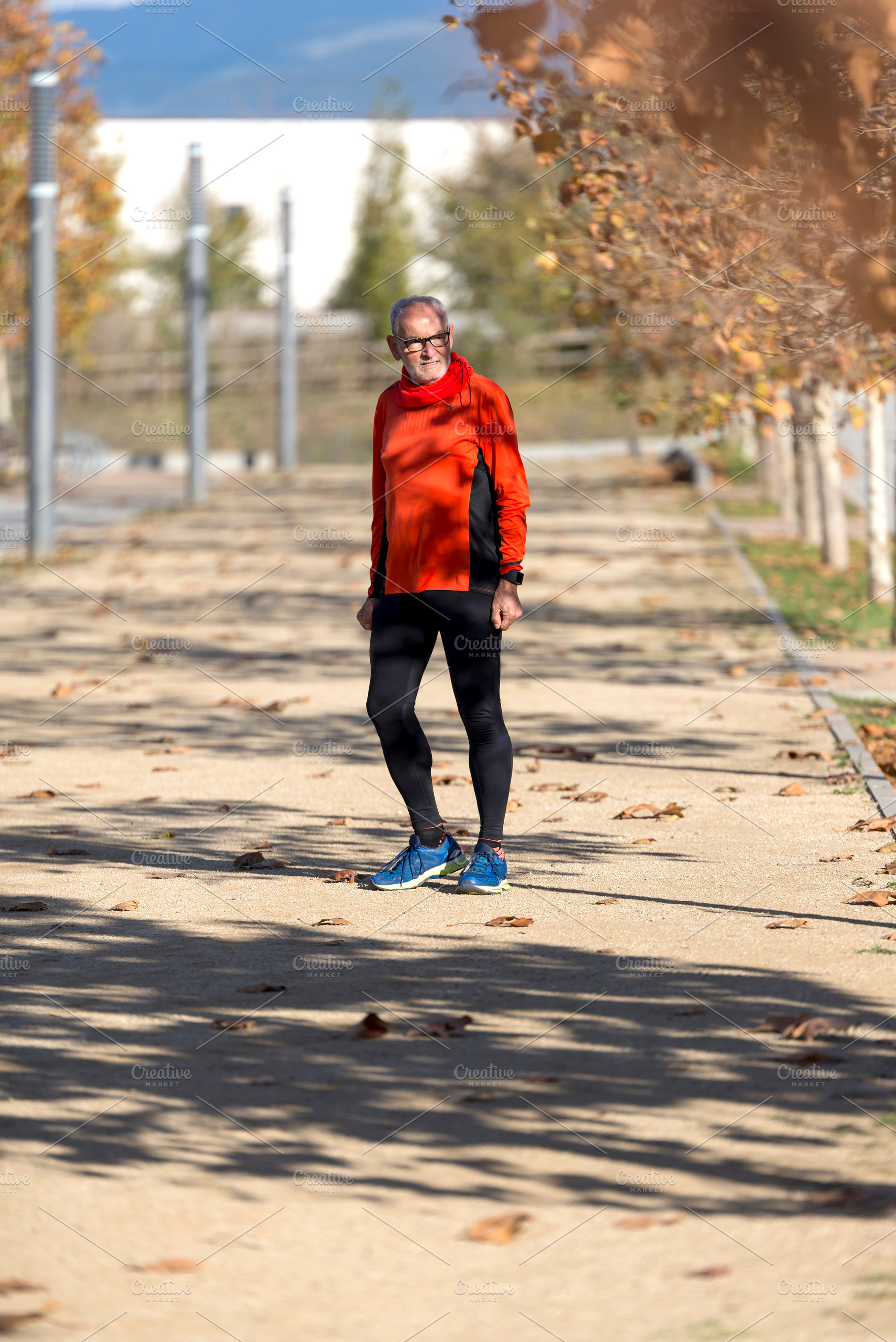 Senior man walking outdoors on a sunny autumn day, a Sports & Recreation Photo by RF Images